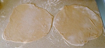 Roll out two roti, making sure that they are roughly the same shape and size.